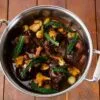 Red wine braised beef cheeks with glazed onions, smoked bacon and wild mushroom
