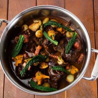 Red wine braised beef cheeks with glazed onions, smoked bacon and wild mushroom