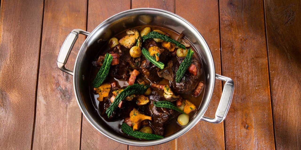 Red wine braised beef cheeks with glazed onions, smoked bacon and wild mushroom